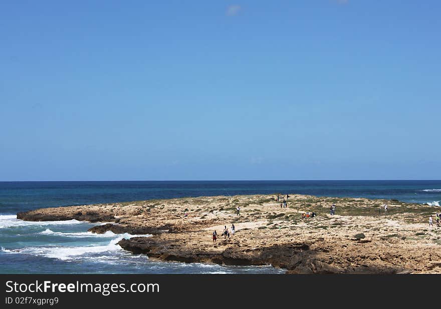 Seascape. Blue sky, sea and a lot of tourists.