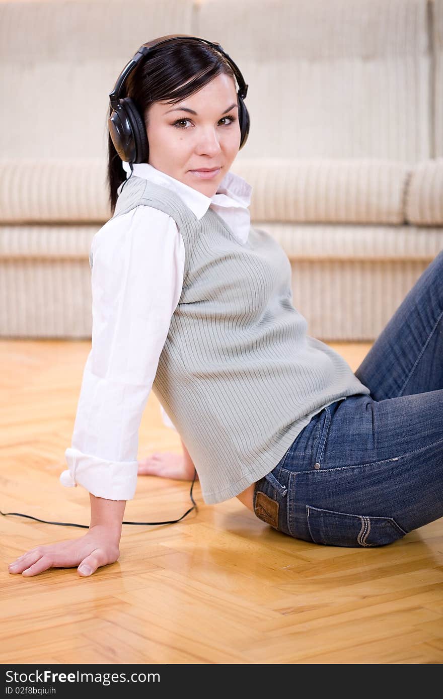 Young adult woman with headphones at home. Young adult woman with headphones at home