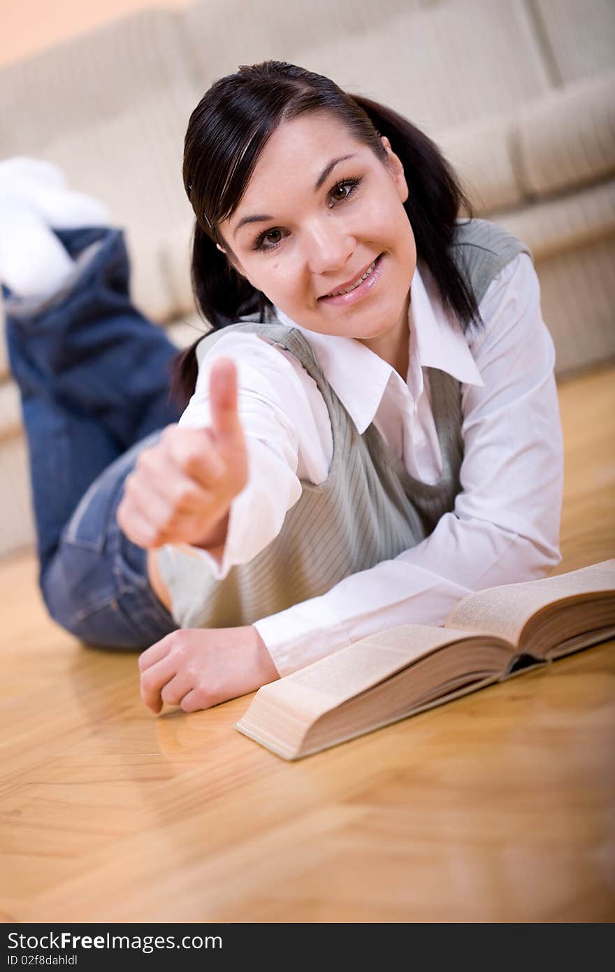 Youing brunette woman reading book at home