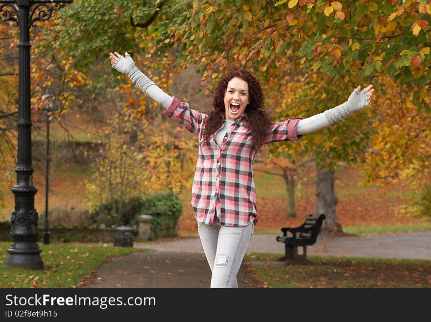 Teenage Girl Standing In Autumn Park