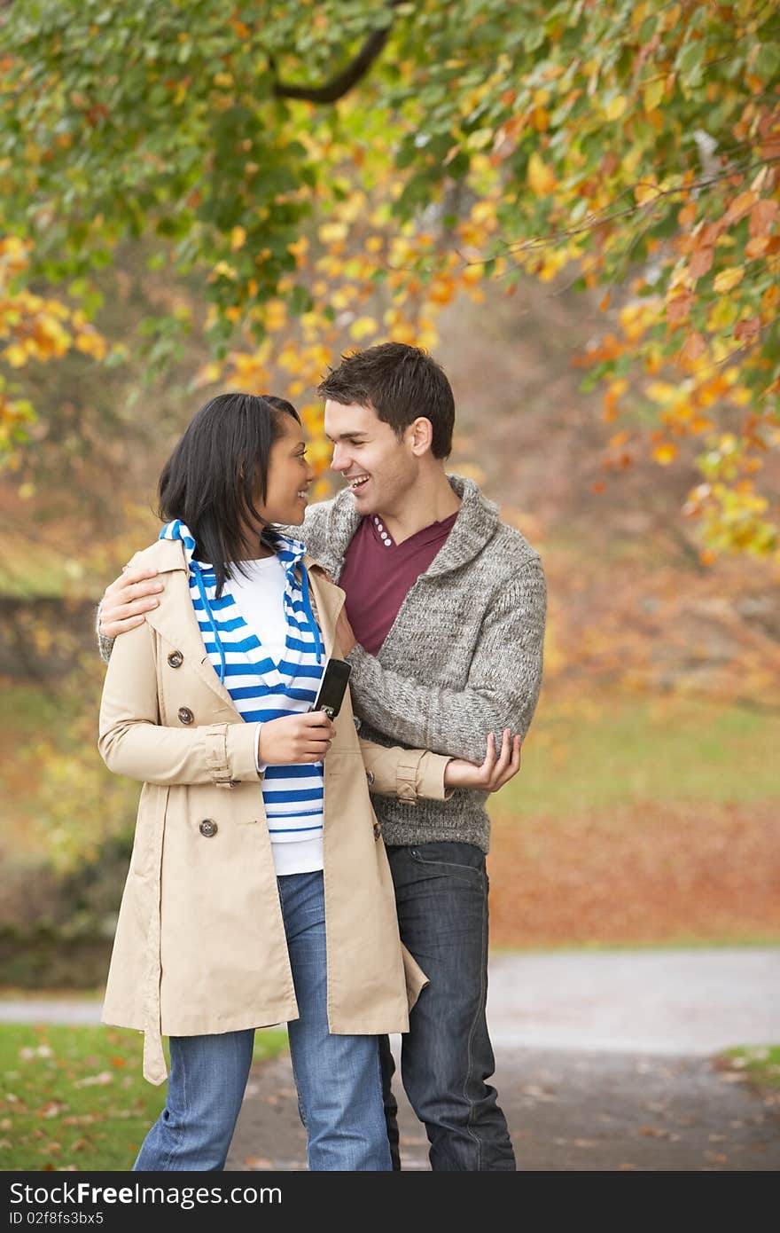 Romantic Teenage Couple In Autumn Park