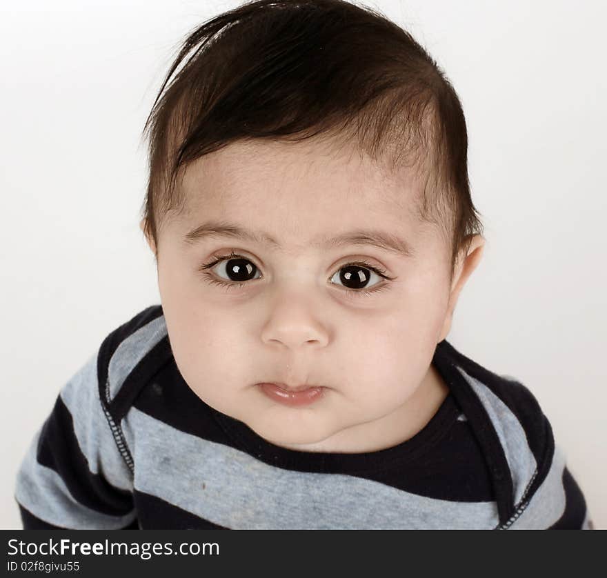 Little baby boy with big dark eyes looking up. Little baby boy with big dark eyes looking up.