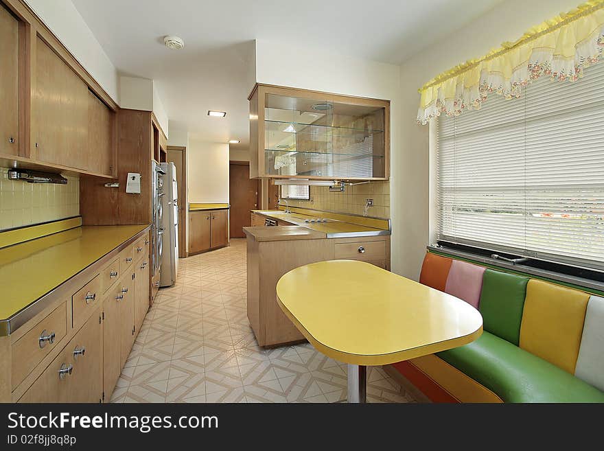 Kitchen with yellow table and multicolored booth. Kitchen with yellow table and multicolored booth