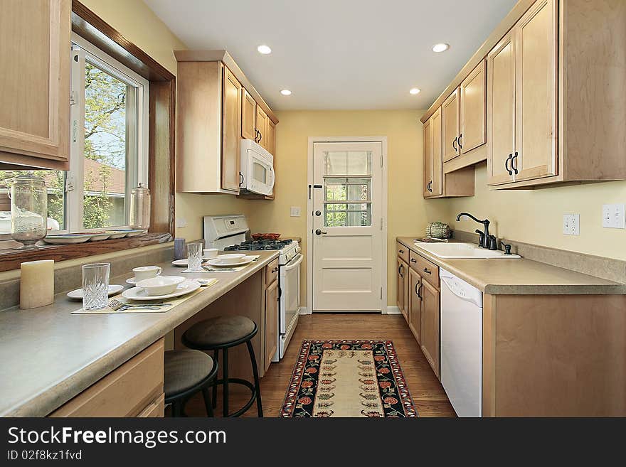 Kitchen in suburban home with oak wood cabinetry. Kitchen in suburban home with oak wood cabinetry