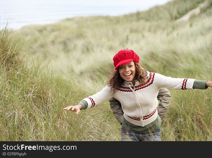 Teenage Girl Walking Through Sand Dunes