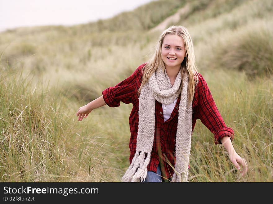 Teenage Girl Walking Through Sand Dunes