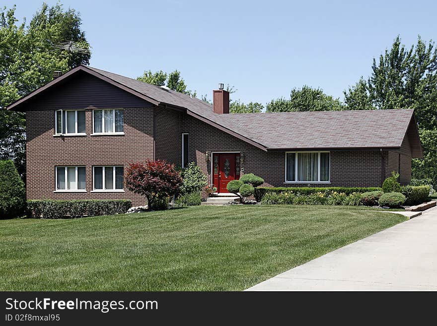 Brick home in suburbs with red door. Brick home in suburbs with red door