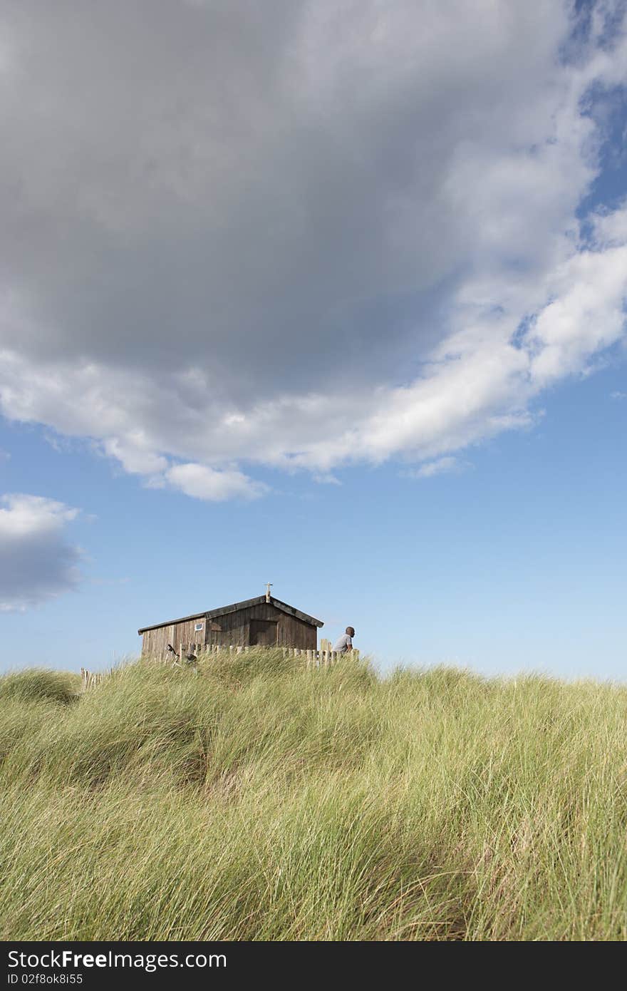 Distant View Of Young Couple Relaxing In Wooden Be