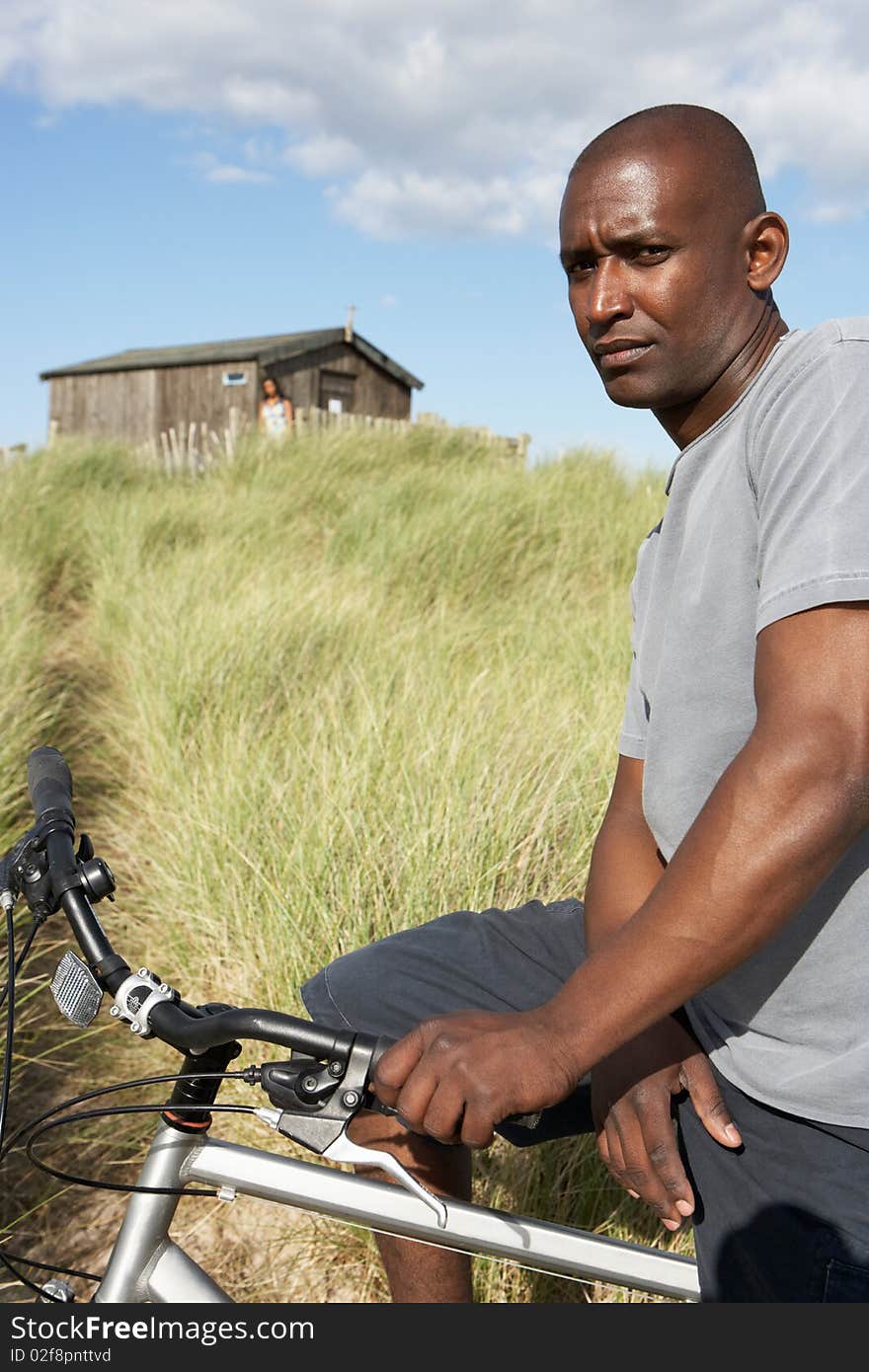 Young Man Riding Mountain Bike By Dunes