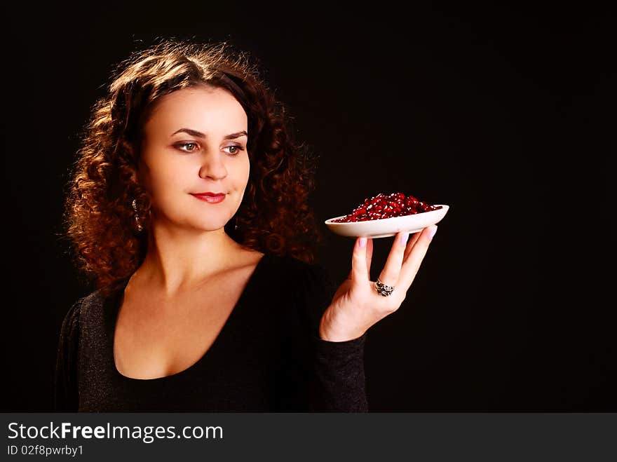 Portrait of a beautiful woman with seeds of pomegranate. Studio shot. Portrait of a beautiful woman with seeds of pomegranate. Studio shot.