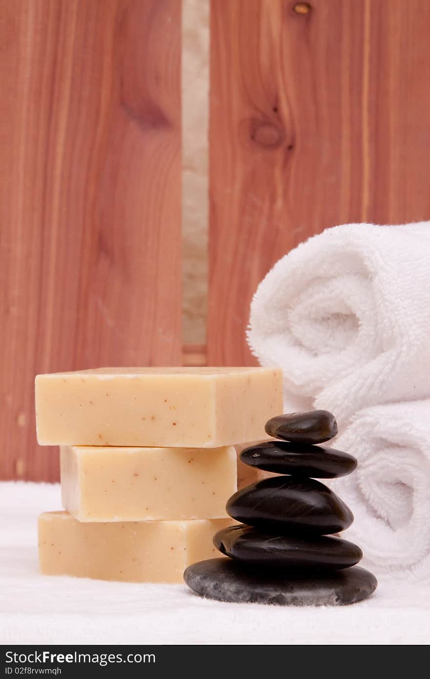 Stack of lastone therapy rocks with towels and soap