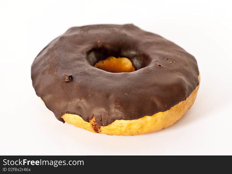 A closeup detail of an isolated Chocolate donut. A closeup detail of an isolated Chocolate donut