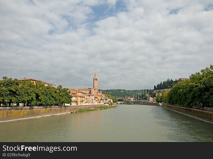 The river and view of basilica di sant anastasia from the bridge of ponte nuovo at verona in italy. The river and view of basilica di sant anastasia from the bridge of ponte nuovo at verona in italy