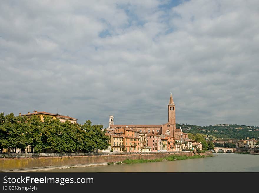 The river and view of basilica di sant anastasia from the bridge of ponte nuovo at verona in italy. The river and view of basilica di sant anastasia from the bridge of ponte nuovo at verona in italy