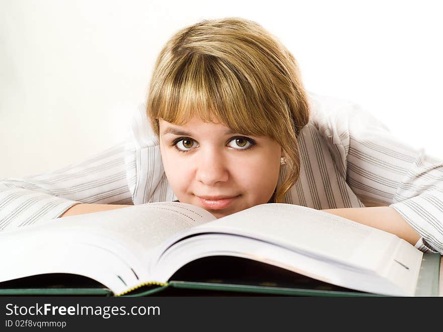 Young student with a book on white