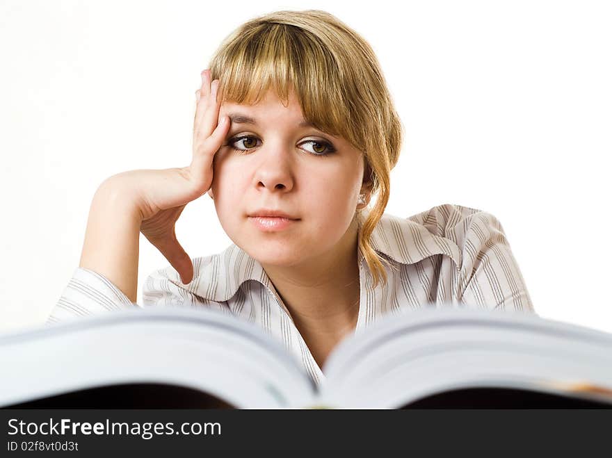 Beautiful young girl with a book on white background