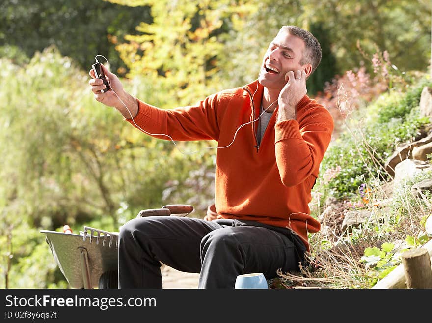 Man Outdoors Listening To MP3 Player