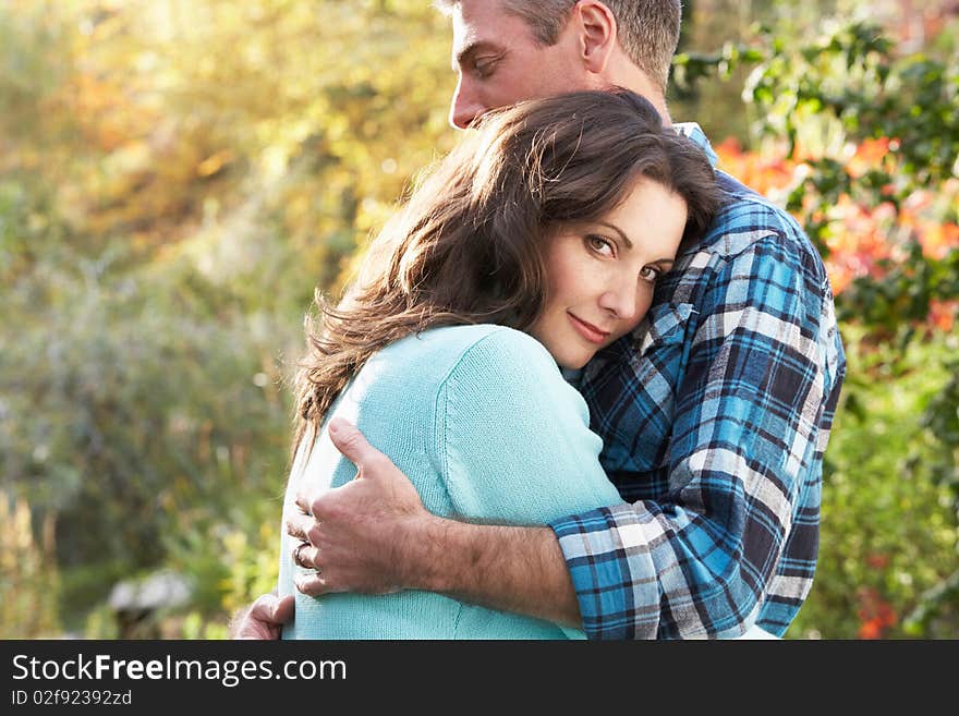 Close Up Of Romantic Couple Embracing By Autumn Woodland. Close Up Of Romantic Couple Embracing By Autumn Woodland