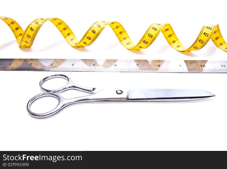 Yellow centimetre and steel scissors isolated on white. Yellow centimetre and steel scissors isolated on white