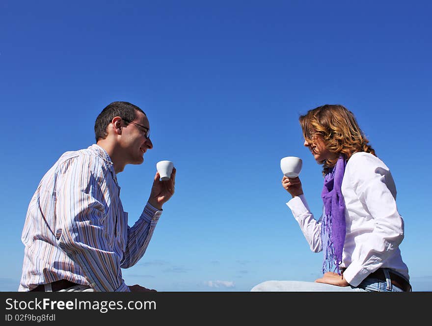 Young happy couple drinking coffee