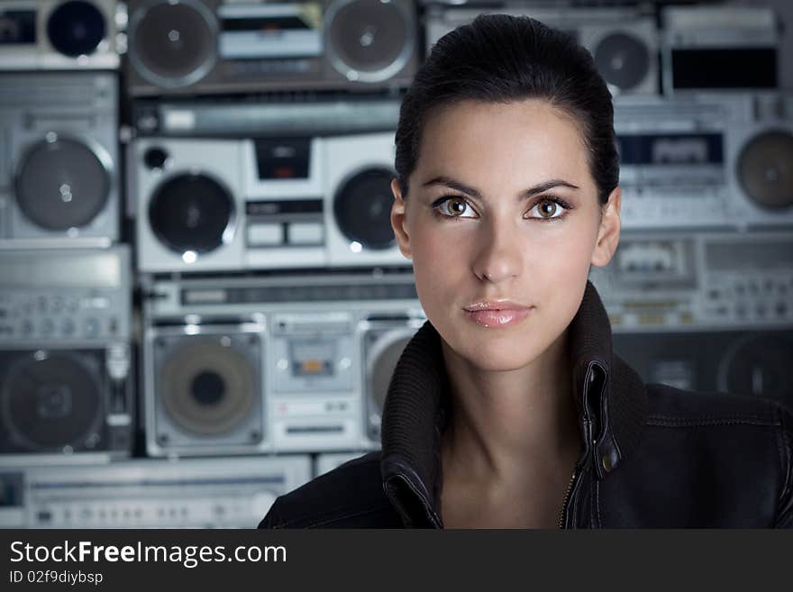 Beautiful woman with Boom Box background. Rock style