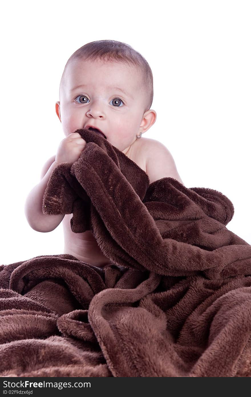 A beautiful baby under a brown towel