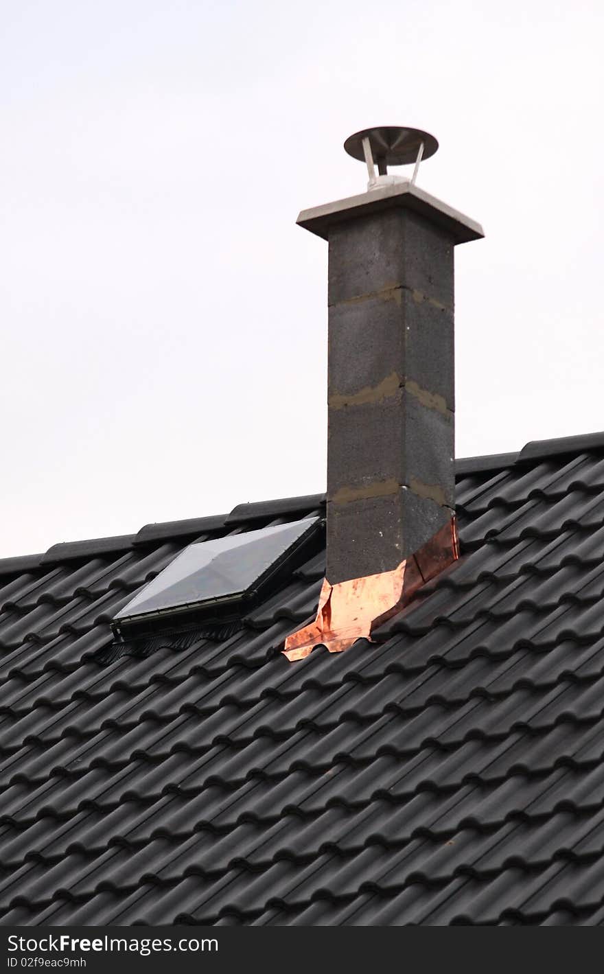 Chimney on black roof. new house