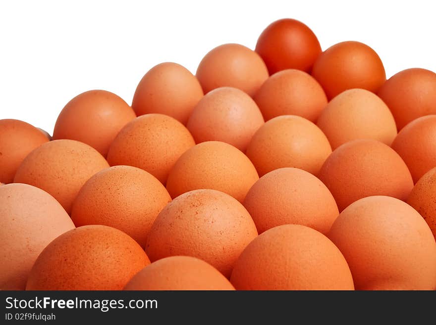 Brown eggs placed closely together isolated over white background. Brown eggs placed closely together isolated over white background.