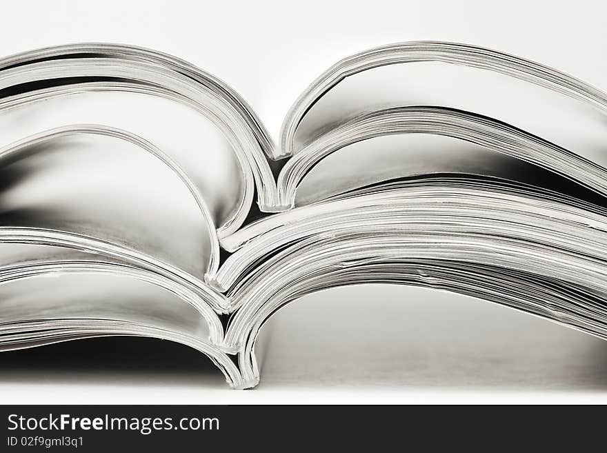 Stack of magazines on white background