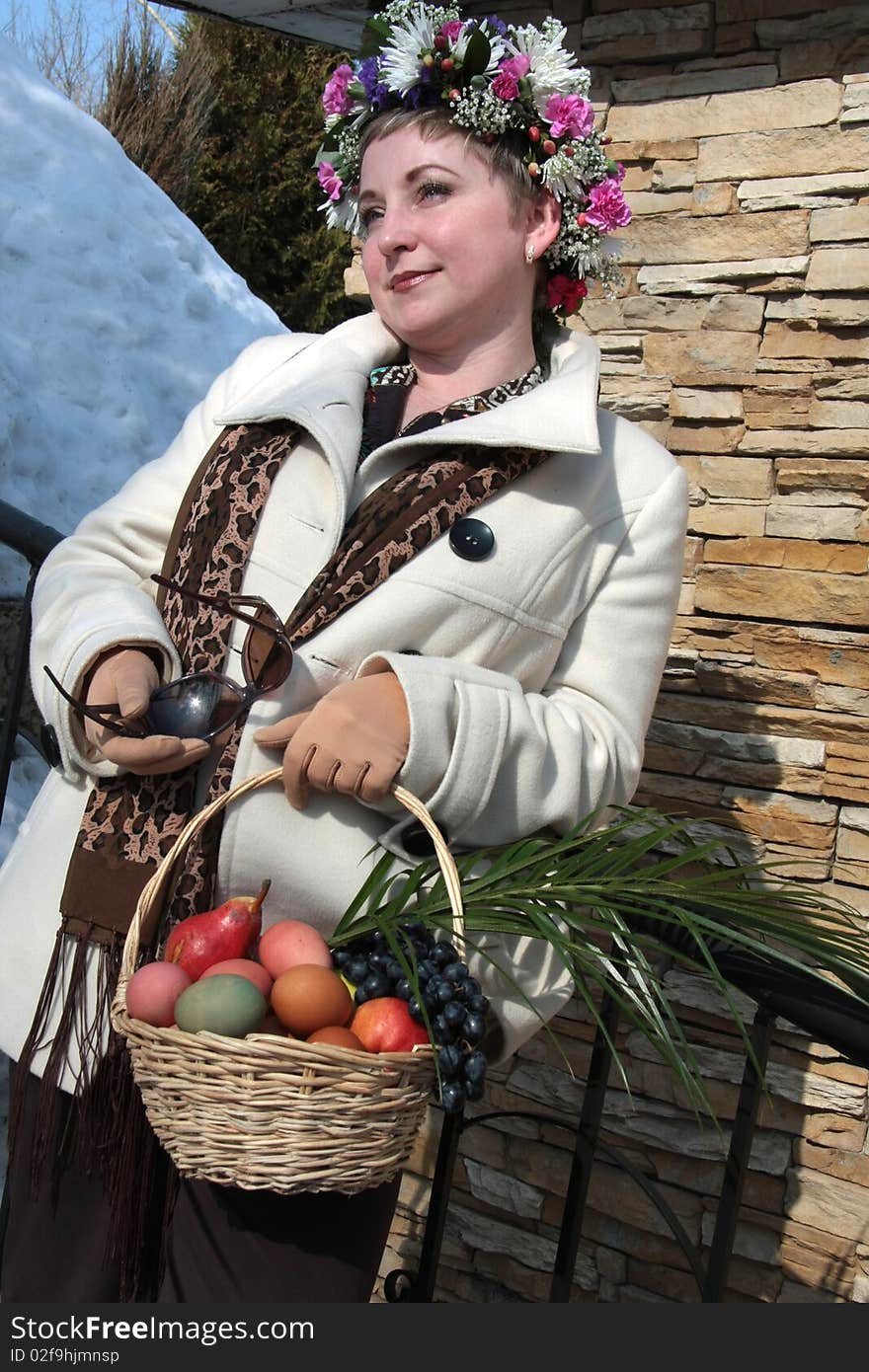 A girl wearing a crown with Easter basket