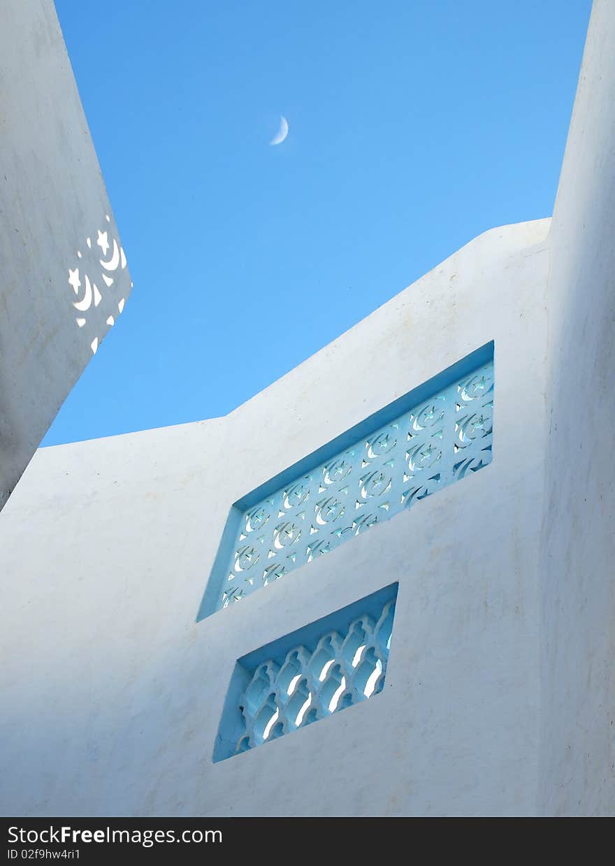 Oriental street with white walls and blue sky