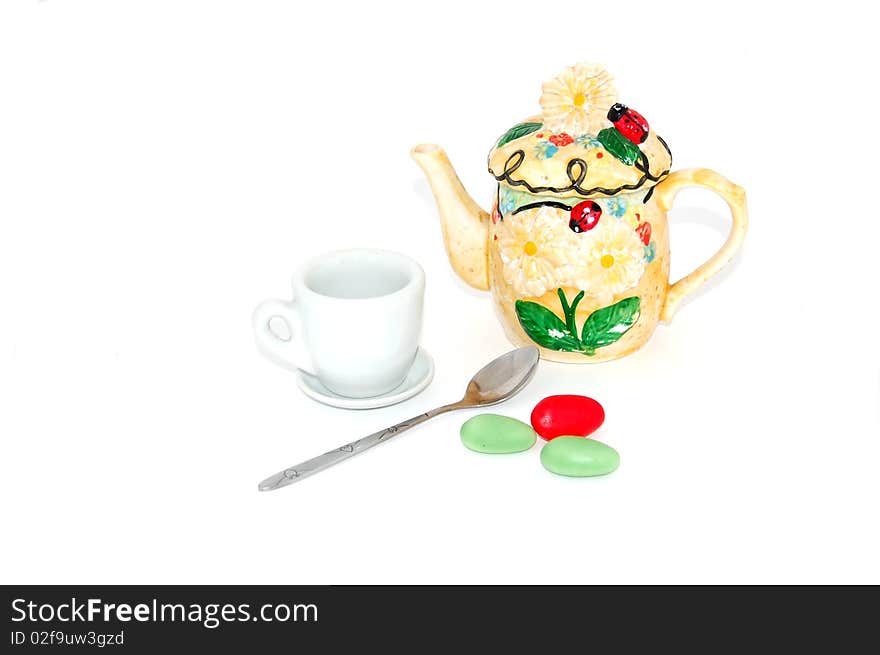 Tea pot,cup,spoon and candy isolated on white. Tea pot,cup,spoon and candy isolated on white.