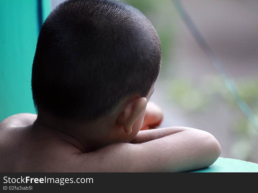 Little boy looking out of the balcony