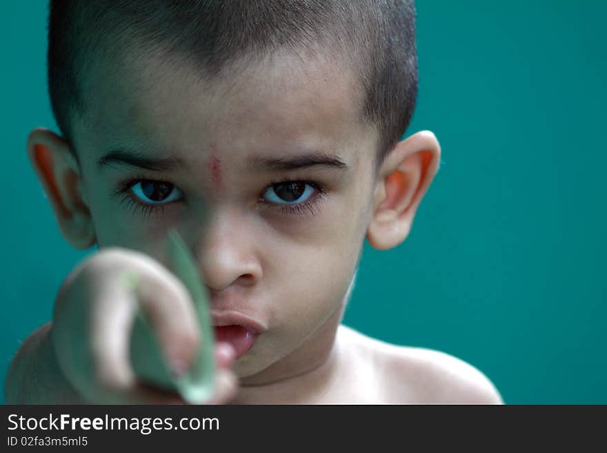 Indian cute boy posing to the camera with an expression