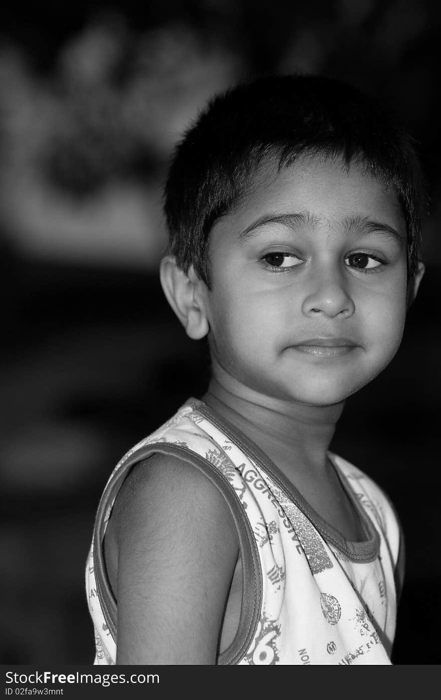 An handsome indian kid looking very thoughtful