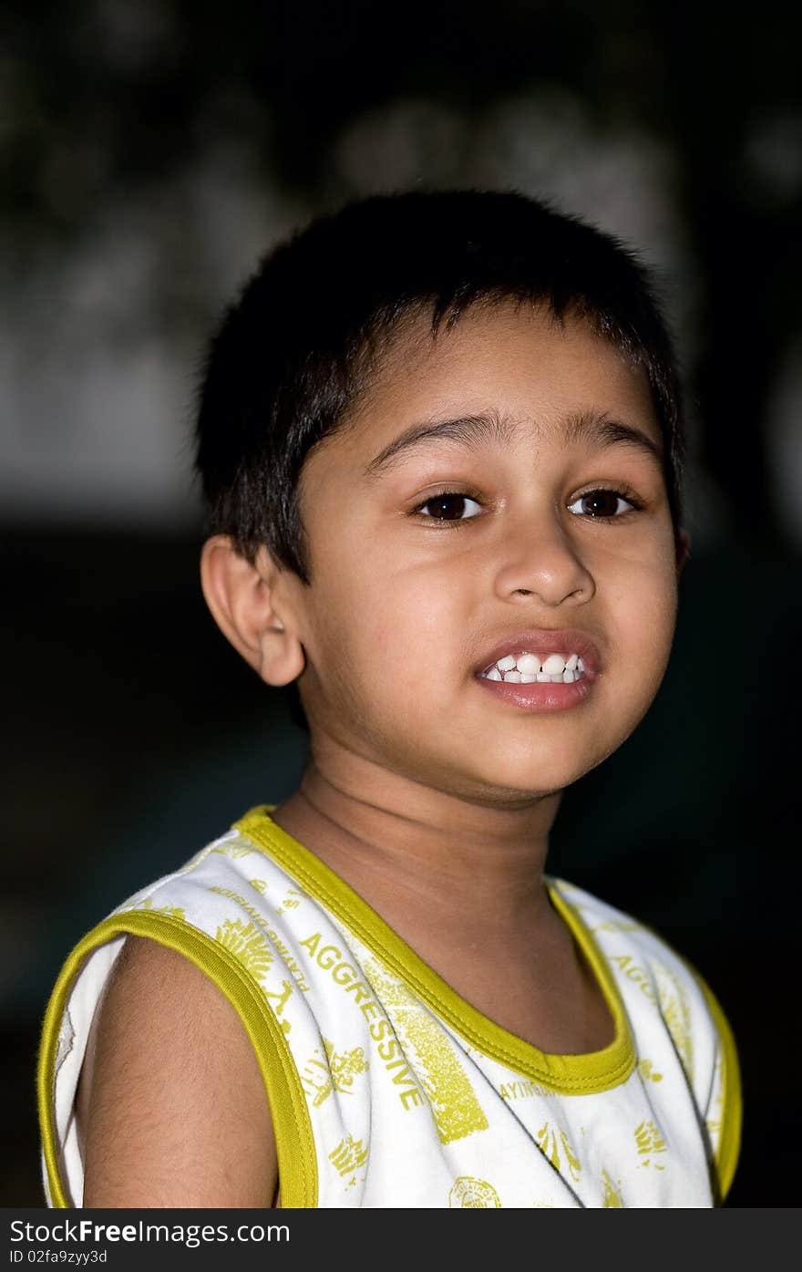 An handsome indian kid looking very thoughtful