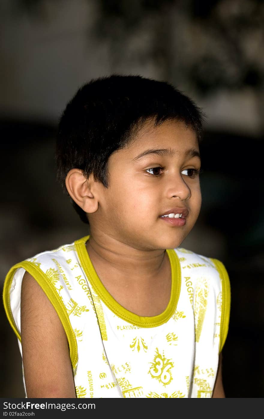 An handsome indian kid looking very thoughtful