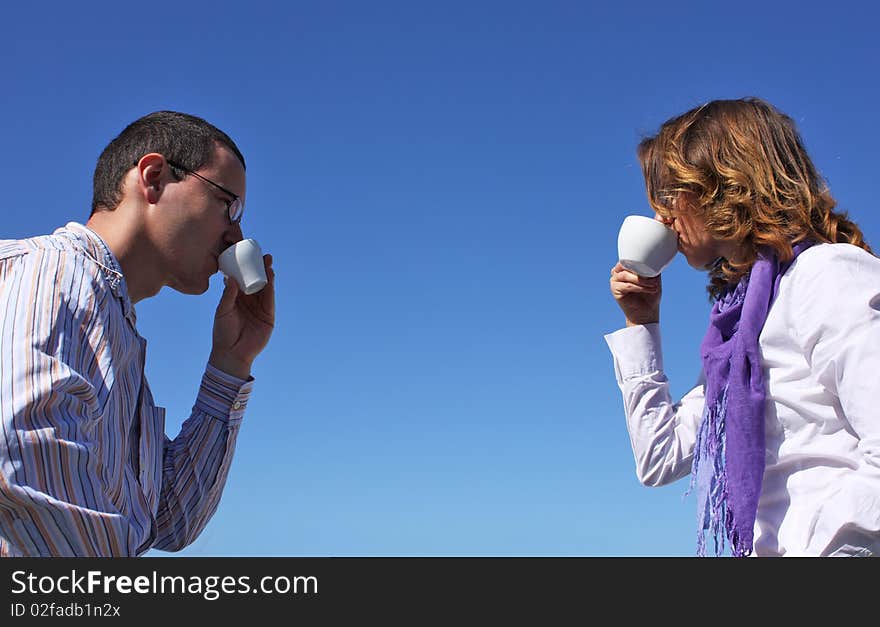 Young happy couple drinking coffee