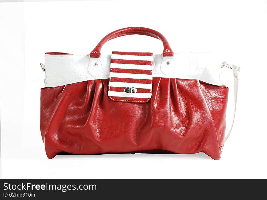 This is beautiful red and white leather ladies handbag isolated on a white background. This is beautiful red and white leather ladies handbag isolated on a white background.