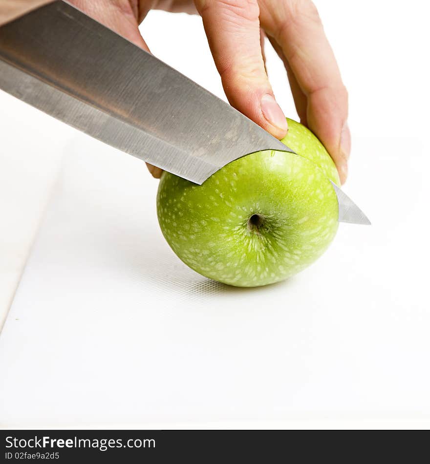 Sliced green apple in multiple peices with knife. Sliced green apple in multiple peices with knife