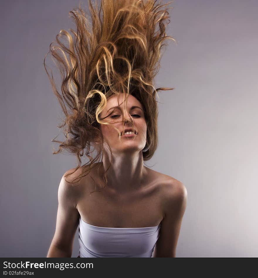 Dancing young girl waves the hairs