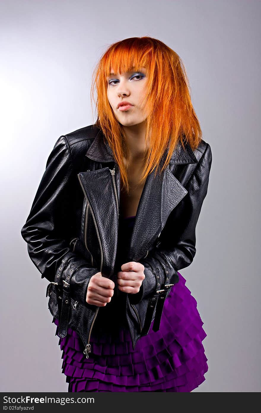 Fashionable dancing girl in a leather jacket