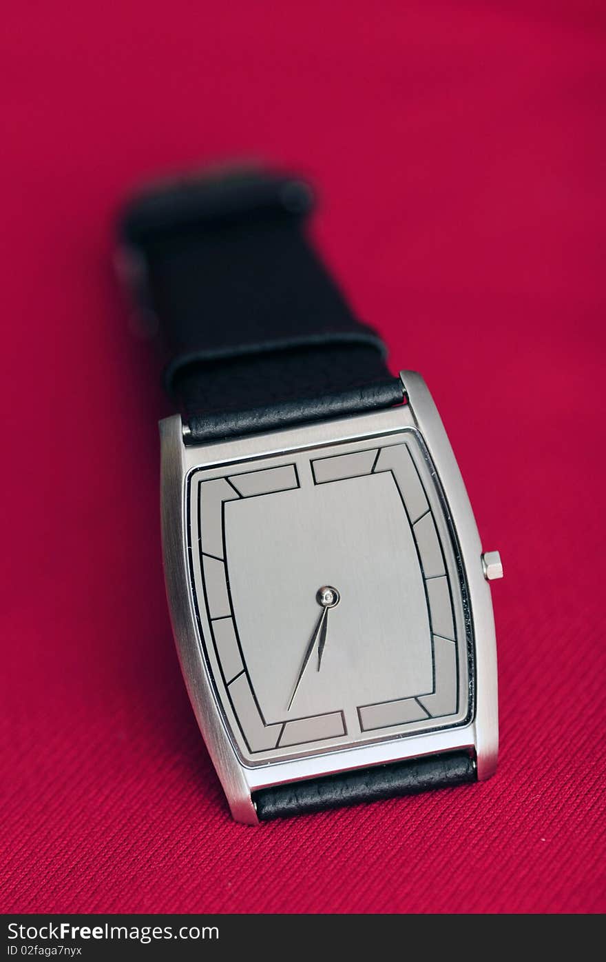 A wrist watch isolated on a red background