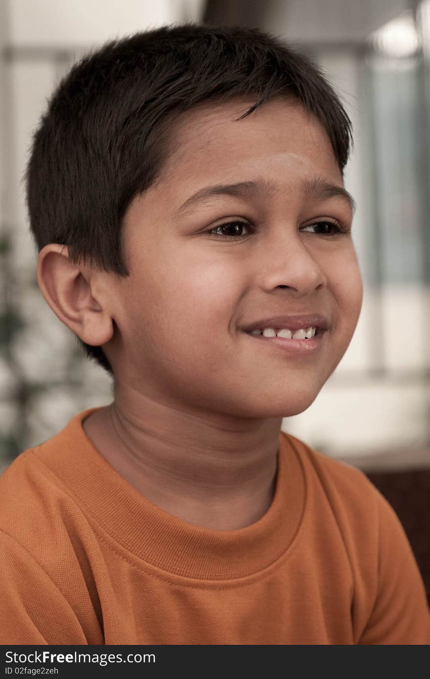 Handsome Indian kid smirking in front of the camera