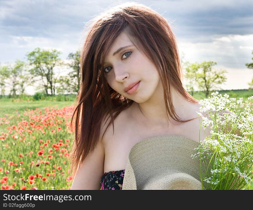 Beautiful young girl in summer field