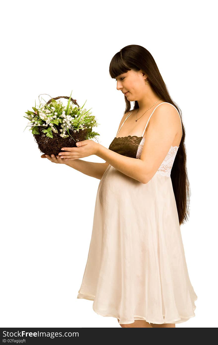 A pregnant woman holding a basket of lilies of the valley. A pregnant woman holding a basket of lilies of the valley