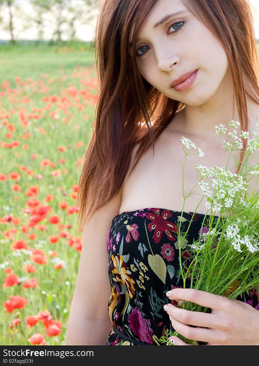 Beautiful young girl in summer field