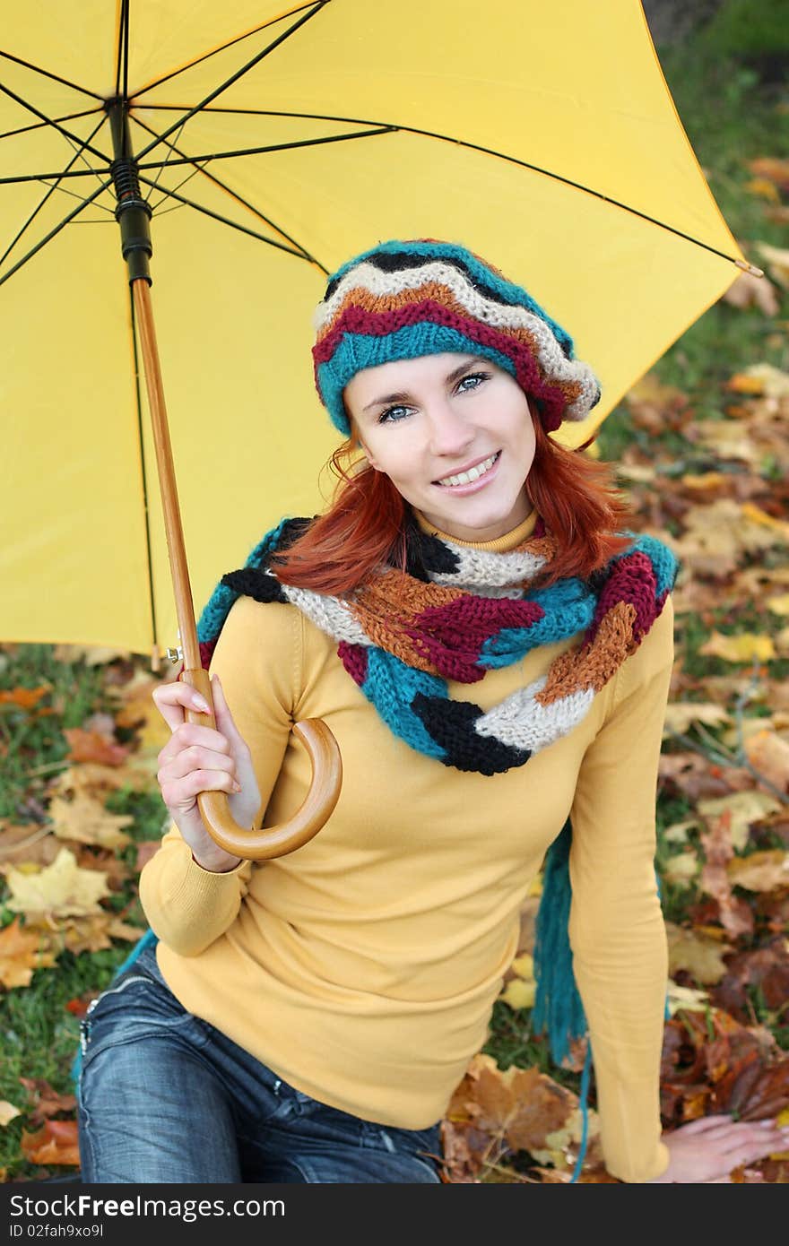 The beautiful young woman on walk in autumn park