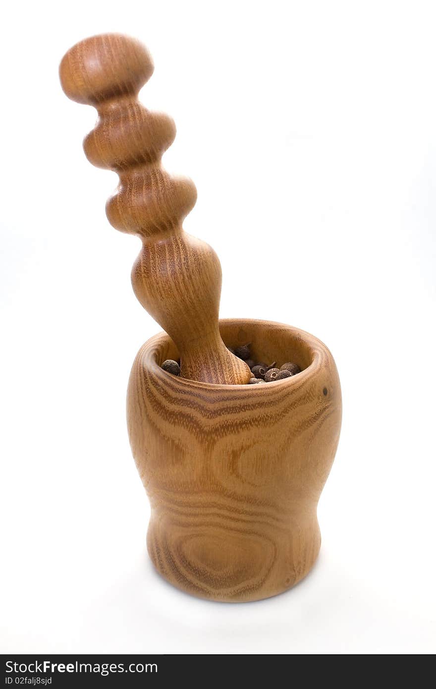 Wooden mortar and pestle with allspice