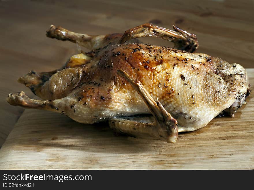 Roasted duck on wooden table